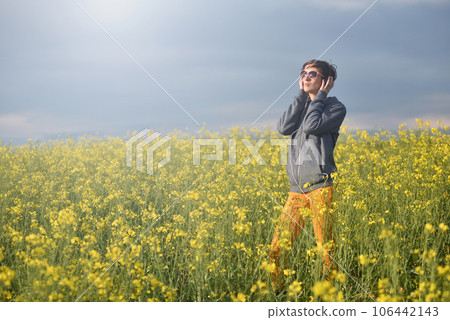 Girl listening to music in the outdoors Girl listening to music in the outdoors 106442143