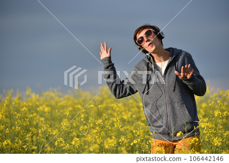 Girl listening to music in the outdoors Girl listening to music in the outdoors 106442146