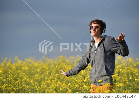 Girl listening to music in the outdoors Girl listening to music in the outdoors 106442147