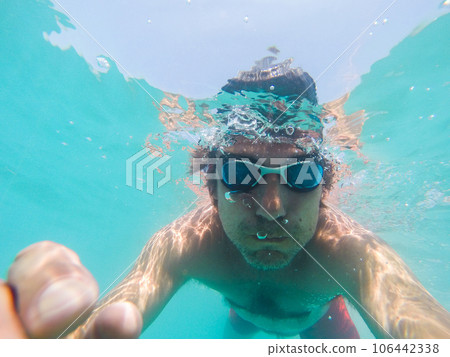 Underwater view of a man swimming in the sea 106442338