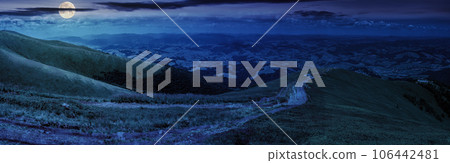 panoramic mountain landscape at night. winding trail path through the meadow down the hill. wonderful distant countryside scenery in full moon light panoramic mountain landscape at night. winding trail path through the meadow down the hill. wonderful distant countryside scenery in full moon light 106442481
