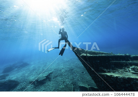 Freediver Sitting at Shipwreck Under the Sea Level and Showing OK Symbol. 106444478