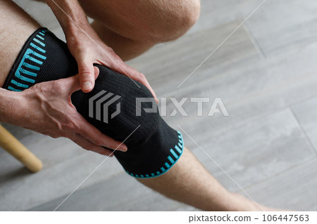Closeup Knee Support Brace on male leg. Elastic orthopedic orthosis anatomic braces Closeup Knee Support Brace on male leg. Elastic orthopedic orthosis anatomic braces 106447563