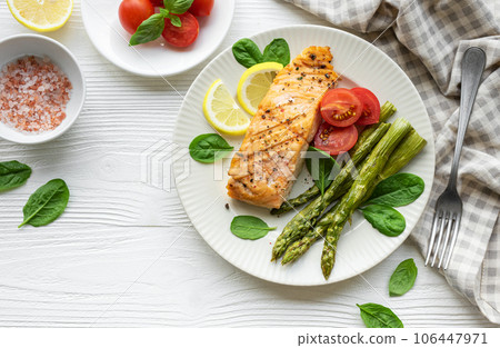 Baked Delicious salmon, green asparagus on  plate 106447971
