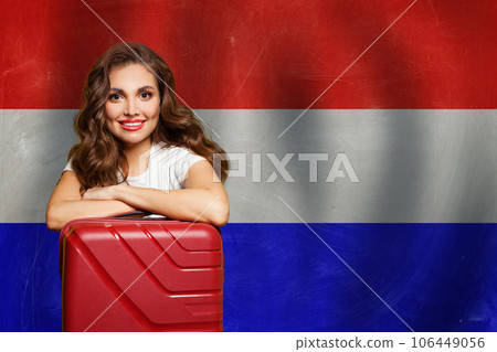 Welcome to Netherlands. Cute smiling woman with red suitcase on flag of Netherlands background Welcome to Netherlands. Cute smiling woman with red suitcase on flag of Netherlands background 106449056