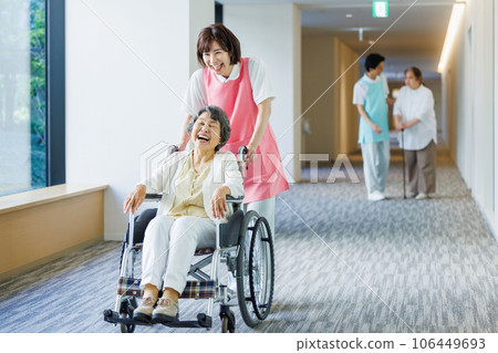 A senior in a wheelchair and a young caregiver Photography cooperation "LINK FOREST" 106449693