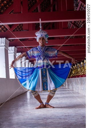 Nora performer performs temple dance moves. The Nora is a traditional dance of Southern in Thailand. Beautiful jewelry with bright colors. Delicate and powerful dance moves. 106450077