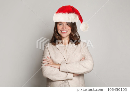Beautiful happy successful confident Christmas model woman Santa standing on white background 106450103