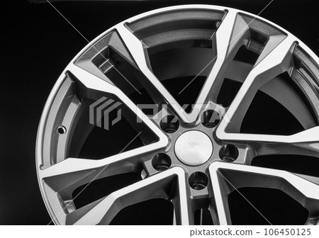 Cast disc, aluminum wheel close up. Polished front part and gray color. Auto parts close-up 106450125