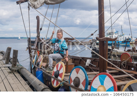 woman tourist aboard a modern replica of ancient viking longship woman tourist aboard a modern replica of ancient viking longship 106450175