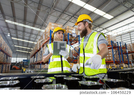 Male and Female professional worker wearing safety uniform using tablet inspect goods Male and Female professional worker wearing safety uniform using tablet inspect goods 106450229