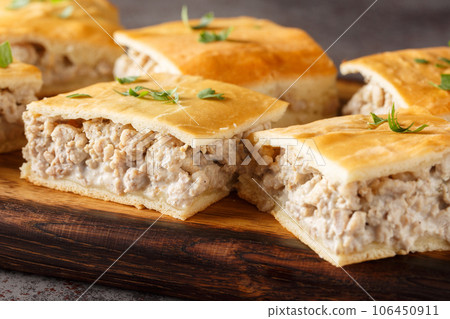 Delicious breakfast casserole of italian sausages with cream cheese close-up on a wooden board. horizontal Delicious breakfast casserole of italian sausages with cream cheese close-up on a wooden board. horizontal 106450911