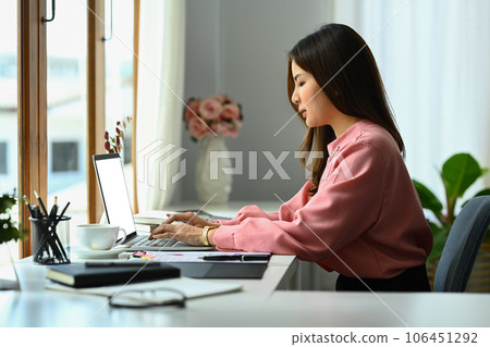 Beautiful businesswoman analyzing marketing data, statistics on laptop computer screen Beautiful businesswoman analyzing marketing data, statistics on laptop computer screen 106451292