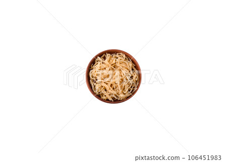Delicious dried squid in the form of shavings with salt and spices on a ceramic plate Delicious dried squid in the form of shavings with salt and spices on a ceramic plate 106451983