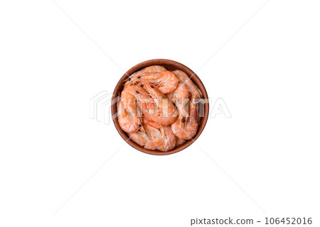 Delicious fresh boiled tiger prawns with salt and spices on a ceramic plate Delicious fresh boiled tiger prawns with salt and spices on a ceramic plate 106452016