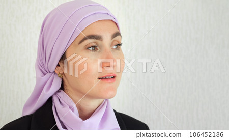 Muslim woman with excited expression looks around in studio 106452186