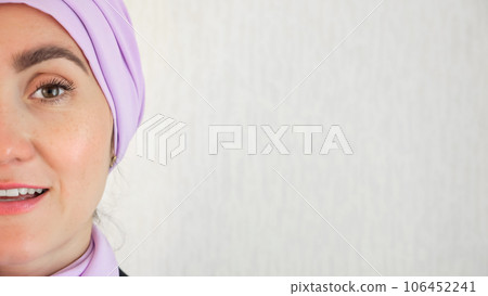 Muslim woman standing with delighted expression at wall Muslim woman standing with delighted expression at wall 106452241