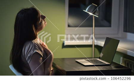 Woman kneads neck after working at laptop for long time Woman kneads neck after working at laptop for long time 106452296