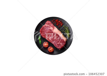 Fresh raw beef striploin steak with salt, spices and herbs Fresh raw beef striploin steak with salt, spices and herbs 106452307