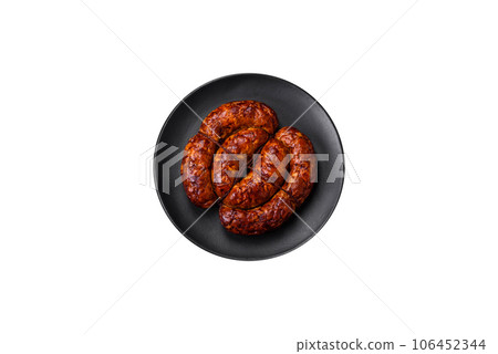 Delicious grilled sausage in the form of a ring with salt, spices and herbs 106452344