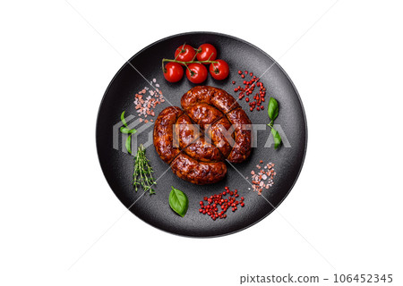 Delicious grilled sausage in the form of a ring with salt, spices and herbs Delicious grilled sausage in the form of a ring with salt, spices and herbs 106452345