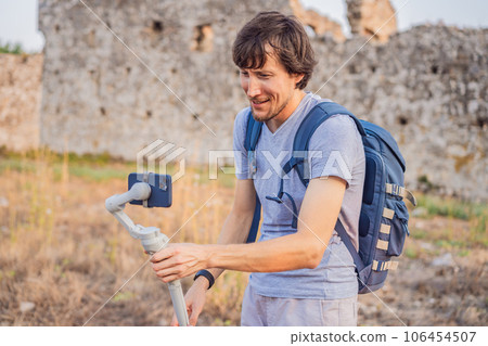 Man tourist explores Aspendos Ancient City. Aspendos acropolis city ruins, cisterns, aqueducts and old temple. Aspendos Antalya Turkey. turkiye Man tourist explores Aspendos Ancient City. Aspendos acropolis city ruins, cisterns, aqueducts and old temple. Aspendos Antalya Turkey. turkiye 106454507