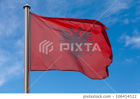 Albanian flag waving atop of its pole Albanian flag waving atop of its pole 106454522
