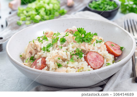 Traditional South Carolina chicken bog dish with smocked sausages, in bowl, horizontal 106454689