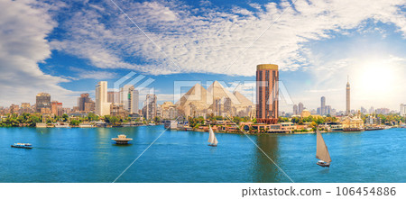 View on the Nile, Cairo city and famous Pyramids in the beautiful panorama of Egypt View on the Nile, Cairo city and famous Pyramids in the beautiful panorama of Egypt 106454886