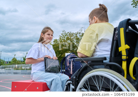 Friendship communication of children of boy in wheelchair and girl Friendship communication of children of boy in wheelchair and girl 106455199