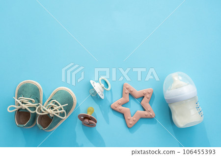 Newborn necessities presented on soft blue, overhead shot with blank space 106455393