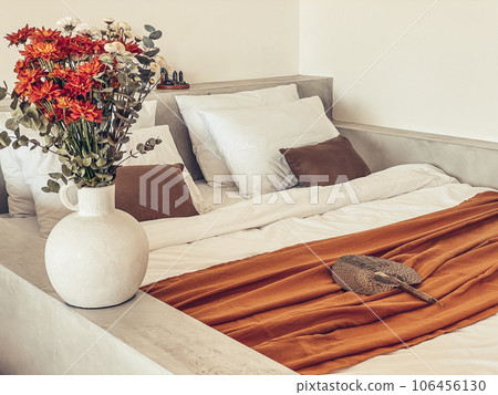 Bouquet of orange chrysanthemums in bedroom 106456130
