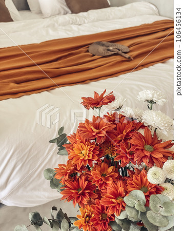 Bouquet of orange chrysanthemums in bedroom 106456134