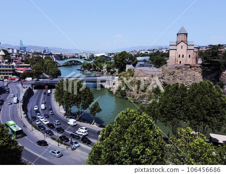 Metekhi church (cathedral) , Metkhi bridge and Kura river and Bridge of Peace in distance and cityscape of Tbilisi 106456686