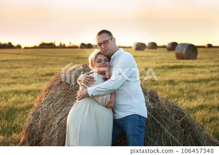blond pregnant woman in white dress with basket on hay field background blond pregnant woman in white dress with basket on hay field background 106457348