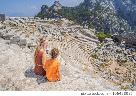 mother and son tourists explores Stunning Ancient Theater of Termessos Ancient City. Traveling with kids concept. turkiye, GO Everywhere 106458055