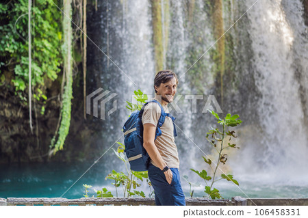 Man on the background of Duden waterfall in Antalya. Famous places of Turkey. Apper Duden Falls 106458331