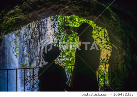 mother and son tourists on the background of Duden waterfall in Antalya. Famous places of Turkey. Apper Duden Falls. 106458332
