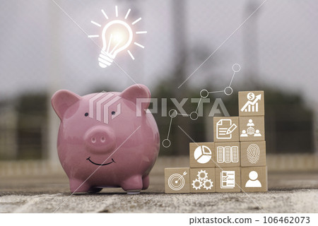 Saving  money.Pig piggy bank with graph business.The icon finance on wood block. save money.investment,bank,finance,Photo financial saving and Saving. 106462073