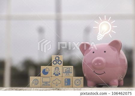 Saving money.Pig piggy bank with graph business.The icon finance on wood block. save money.investment,bank,finance,Photo financial saving and Saving. Saving money.Pig piggy bank with graph business.The icon finance on wood block. save money.investment,bank,finance,Photo financial saving and Saving. 106462075