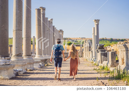 Loving couple of tourists at the ruins of ancient city of Perge near Antalya Turkey. Traveling with kids concept Loving couple of tourists at the ruins of ancient city of Perge near Antalya Turkey. Traveling with kids concept 106463180