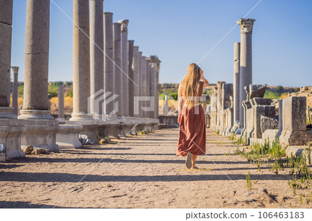 Pretty tourist woman at the ruins of ancient city of Perge near Antalya Turkey 106463183