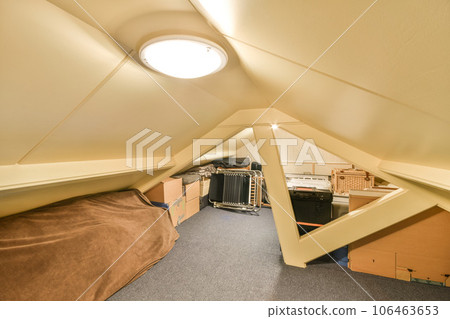 the inside of a room that is being used as an office space for people to work and have their desks 106463653