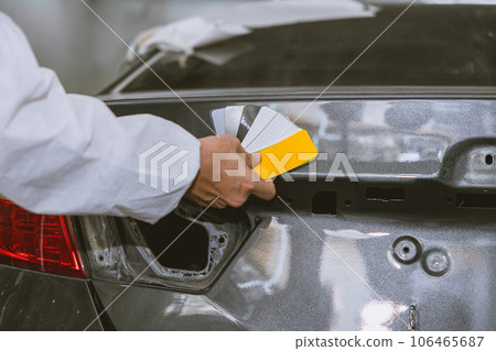car body painter painting select paint colors using sample card for pick choice color shade in auto garage body workshop car body painter painting select paint colors using sample card for pick choice color shade in auto garage body workshop 106465687