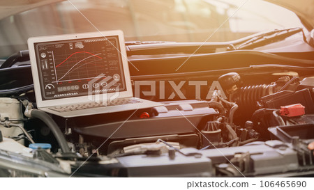 closeup laptop computer with racing car engine ecu speed tuning with modern software display torque and horsepower on screen closeup laptop computer with racing car engine ecu speed tuning with modern software display torque and horsepower on screen 106465690