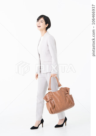 Young female business woman walking in white back Young female business woman walking in white back 106466937