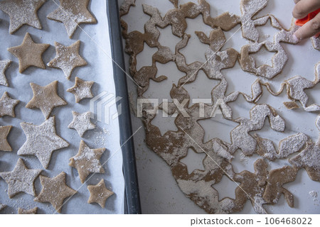 Hands of little 6 years old child with cookies in shape of star. cooking concept Hands of little 6 years old child with cookies in shape of star. cooking concept 106468022