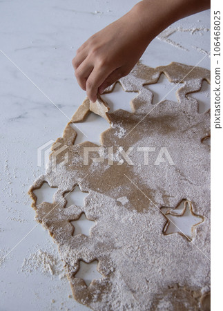 Hands of little 6 years old child with cookies in shape of star. cooking concept Hands of little 6 years old child with cookies in shape of star. cooking concept 106468025