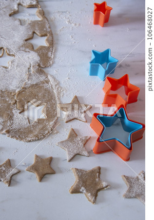 Hands of little 6 years old child with cookies in shape of star. cooking concept 106468027