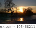 Picturesque sunset over a river covered with snow and ice in winter 106468211